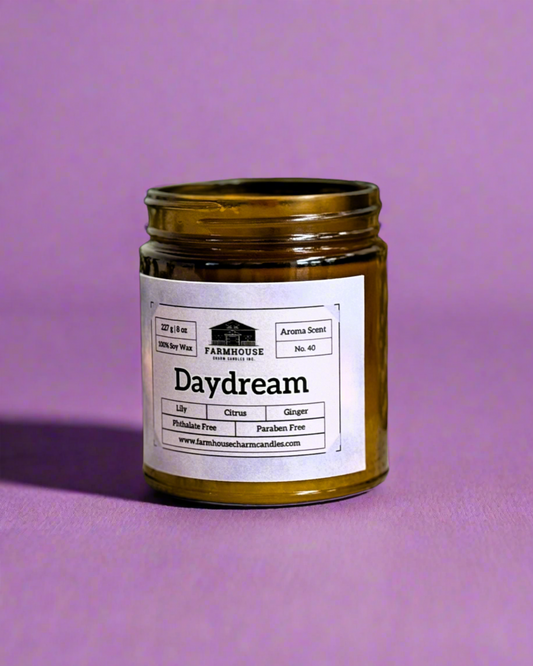 Aroma Scent No. 40 Daydream Soy Candle, a captivating blend designed to ignite inspiration and manifest your dreams. Infused with a medley of citrusy, floral, and spicy notes, this unique fragrance is a delightful fusion of lily's fresh florals, gently accented by hints of ginger and underlying citrus undertones.  These nuanced yet impactful scents serve as a gateway to a realm of positivity, tranquility, and imaginative flair, empowering you to embrace and live out your daydreams.