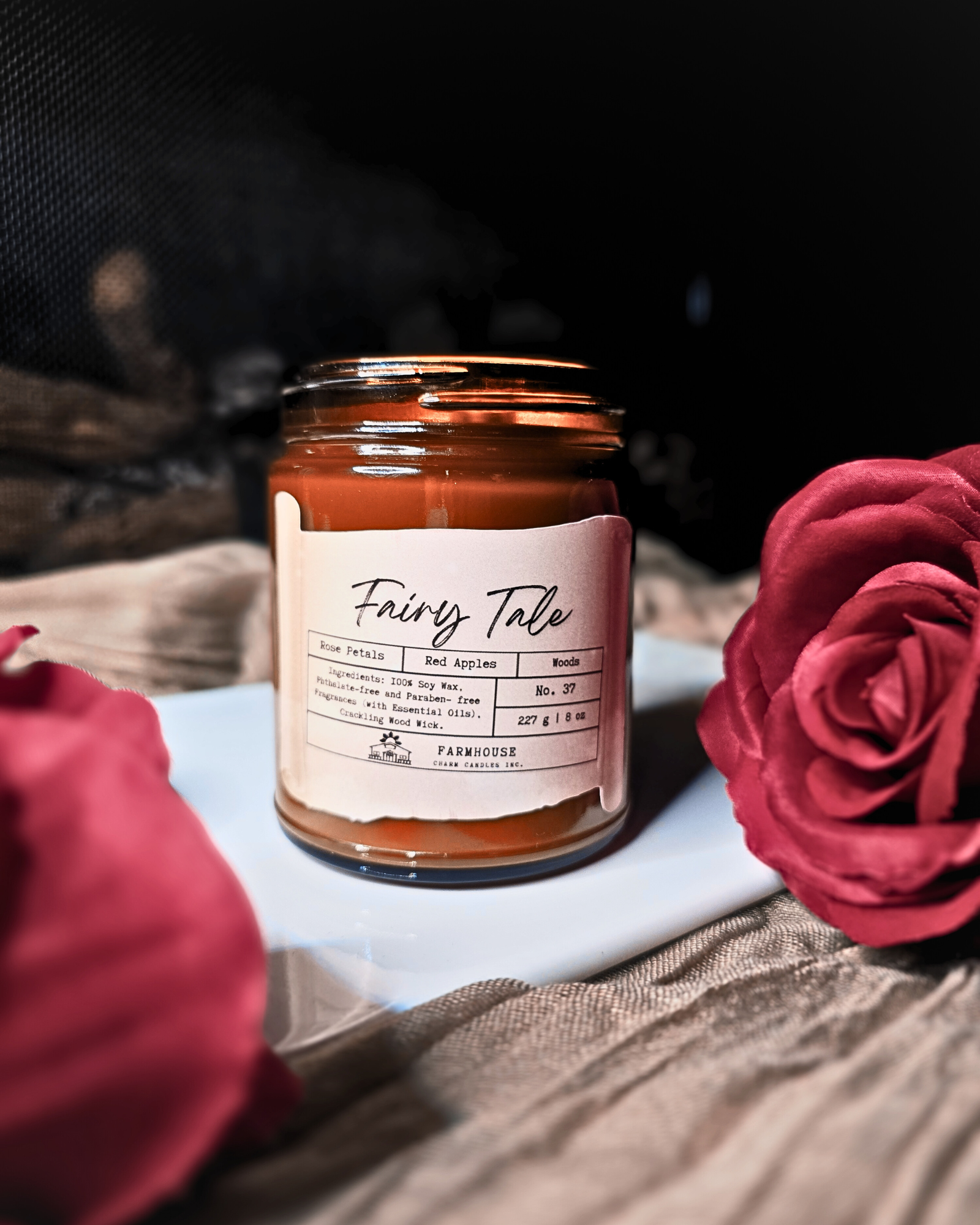 A dreamy blend of blooming rose petals, juicy red apples, and a touch of mystical woods. It’s a scent straight out of your favorite fairy tale—sweet &amp; enchanting,&nbsp; a tale as old as time.

Adorned with delicate, hand-poured white rose embeds (crafted without dyes), each candle is as timeless as the tale itself. Since every candle is handmade, no two are exactly alike—because your happily-ever-after should be as unique as you are. 
www.farmhousecharmcandles.com