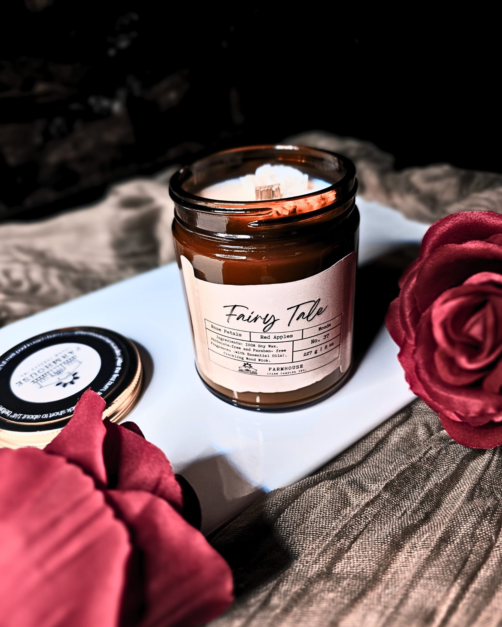 A dreamy blend of blooming rose petals, juicy red apples, and a touch of mystical woods. It’s a scent straight out of your favorite fairy tale—sweet &amp; enchanting,&nbsp; a tale as old as time.

Adorned with delicate, hand-poured white rose embeds (crafted without dyes), each candle is as timeless as the tale itself. Since every candle is handmade, no two are exactly alike—because your happily-ever-after should be as unique as you are. 
www.farmhousecharmcandles.com