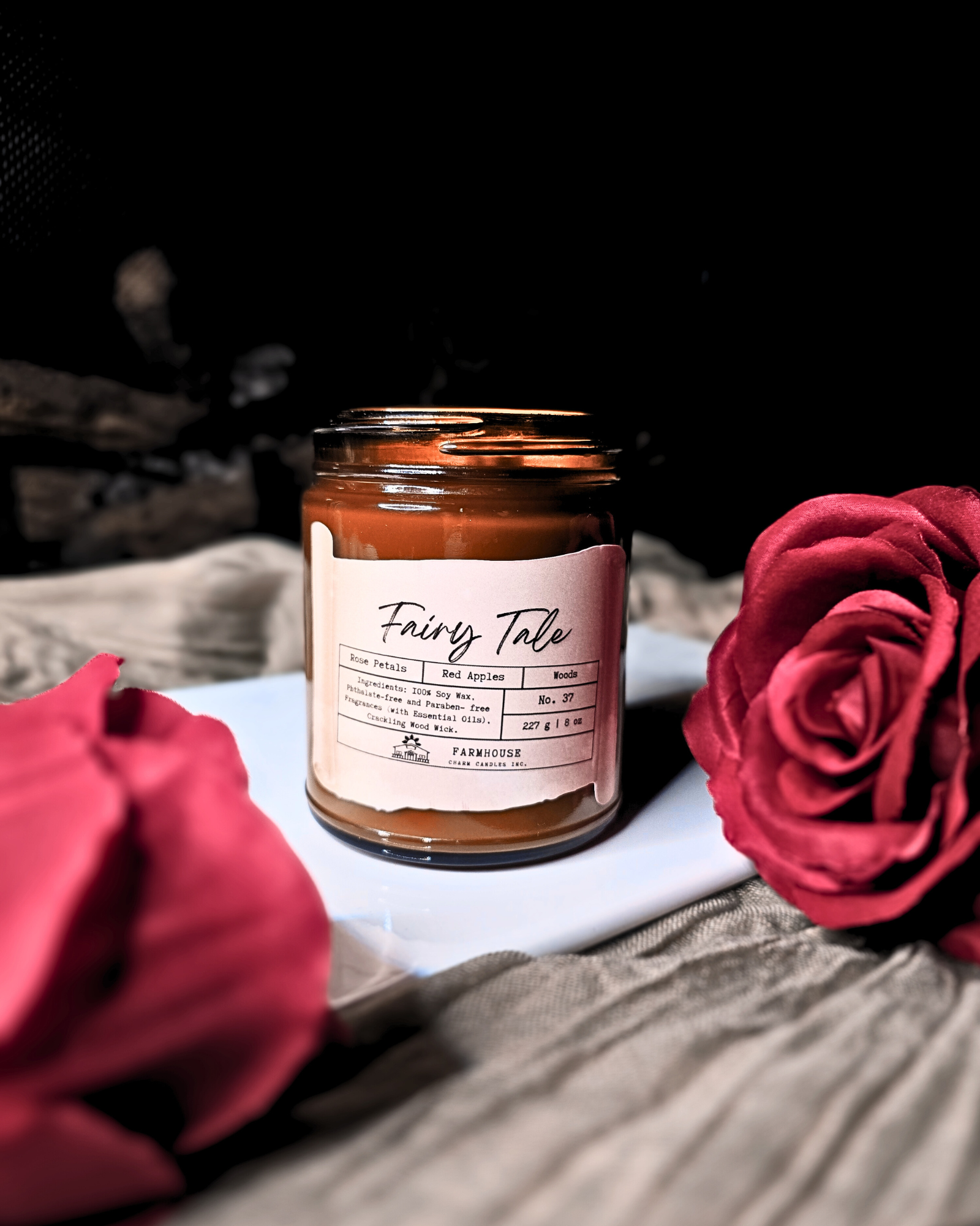 A dreamy blend of blooming rose petals, juicy red apples, and a touch of mystical woods. It’s a scent straight out of your favorite fairy tale—sweet &amp; enchanting,&nbsp; a tale as old as time.

Adorned with delicate, hand-poured white rose embeds (crafted without dyes), each candle is as timeless as the tale itself. Since every candle is handmade, no two are exactly alike—because your happily-ever-after should be as unique as you are. 
www.farmhousecharmcandles.com