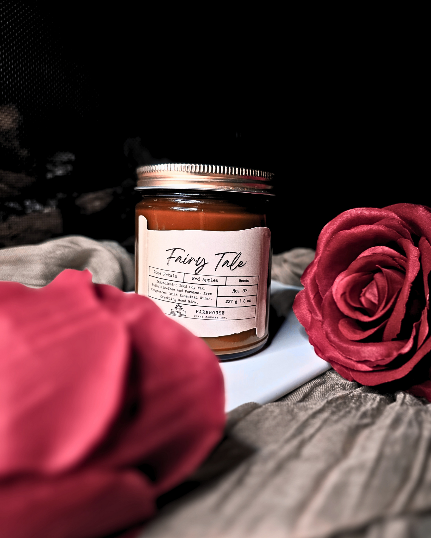 A dreamy blend of blooming rose petals, juicy red apples, and a touch of mystical woods. It’s a scent straight out of your favorite fairy tale—sweet &amp; enchanting,&nbsp; a tale as old as time.

Adorned with delicate, hand-poured white rose embeds (crafted without dyes), each candle is as timeless as the tale itself. Since every candle is handmade, no two are exactly alike—because your happily-ever-after should be as unique as you are. 
www.farmhousecharmcandles.com