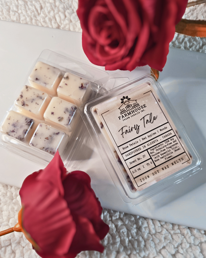 Farmhouse Charm Candles. Bring timeless beauty and a captivating aroma to your space with our Fairy Tale Wax Melts. Inspired by love, nostalgia, and the serene charm of nature, these wax melts feature a harmonious blend of rose petals, crisp red apples, and earthy forest woods.