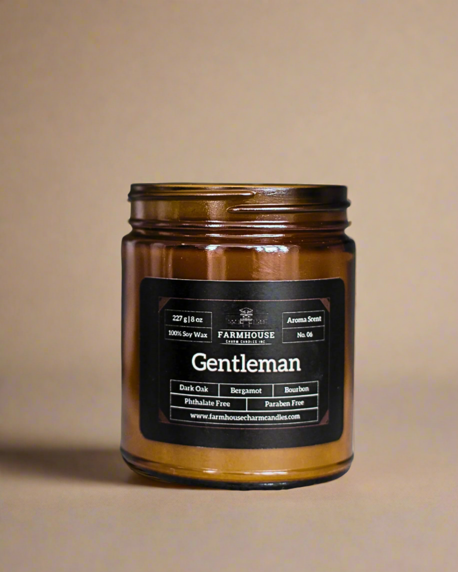 Meet Gentleman—a scent that’s as smooth as a well-aged bourbon and as refined as a tailored suit. Notes of rich dark oak, zesty bergamot, and a warm bourbon finish create an irresistibly dapper aroma that feels like a cozy fireside chat in your favorite leather chair. www.farmhousecharmcandles.com