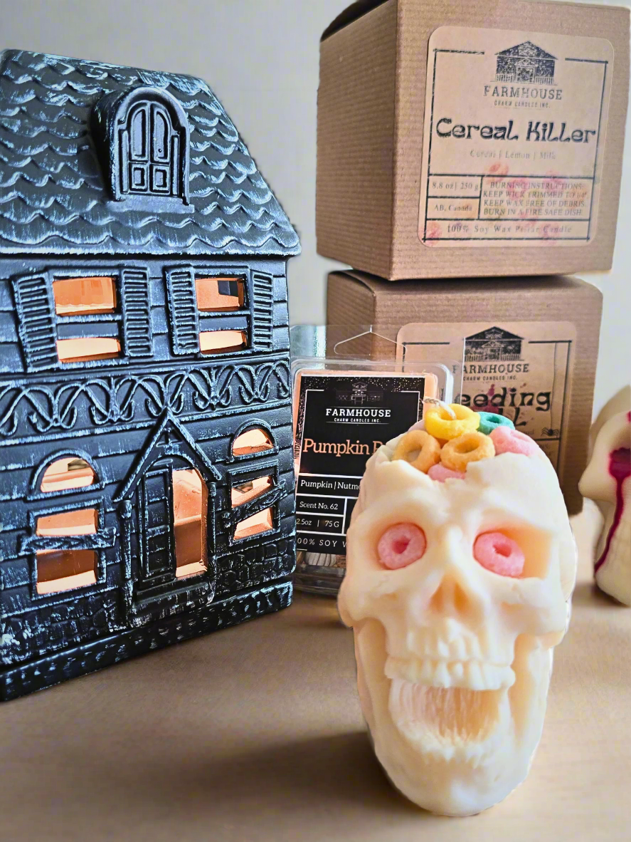 Haunted Essentials: Skulls and Pumpkins Bundle featuring a haunted house fragrance warmer, two skull-shaped soy wax candles, and pumpkin patch soy wax melts. Perfect for Halloween decor with spooky, seasonal scents. www.farmhousecharmcandles.com