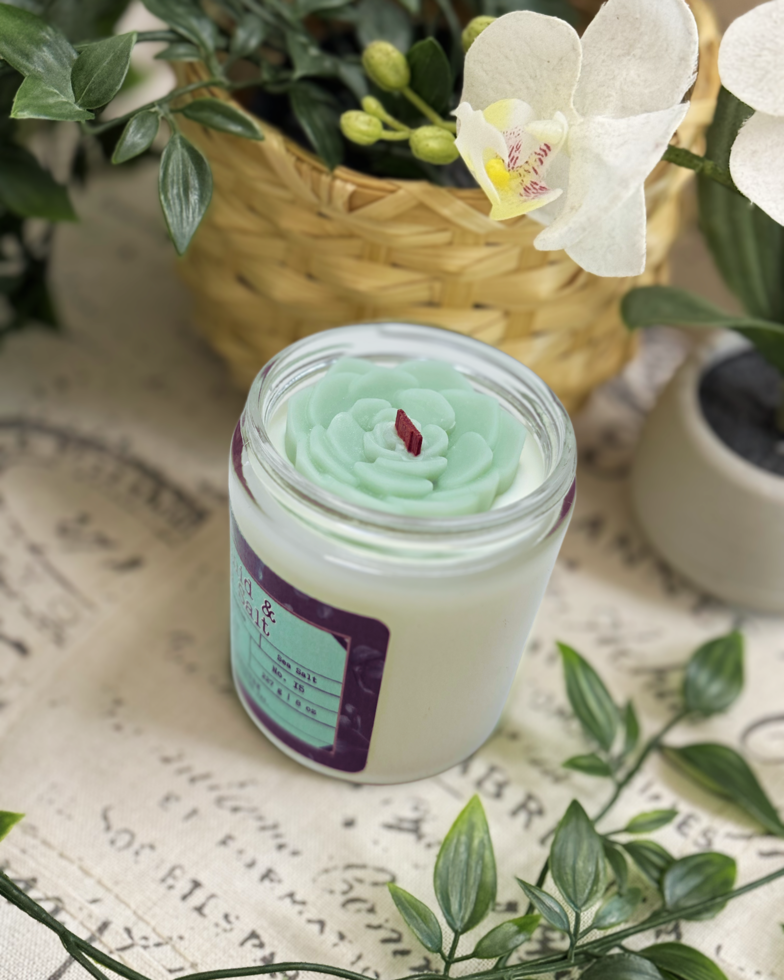 Refreshing blends of floral elegance of orchid and jasmine, kissed by the crisp, clean notes of sea salt. Topped with charming light green succulent wax embeds, it’s a mini oasis in a jar. Orchid & Sea Salt Soy Candle-Farmhouse Charm Candles