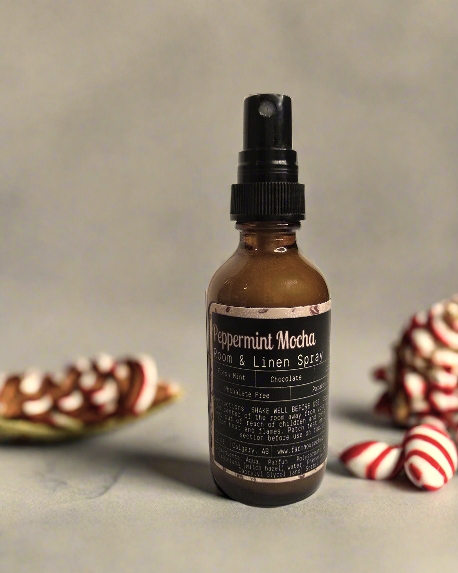 A 2 oz bottle of Peppermint Mocha Room & Linen Spray with a festive blend of coffee, chocolate, and peppermint.
Peppermint Mocha Room & Linen Spray perfect for creating a cozy holiday atmosphere.
Peppermint Mocha Room & Linen Spray bottle placed on a winter-themed background with holiday decorations.