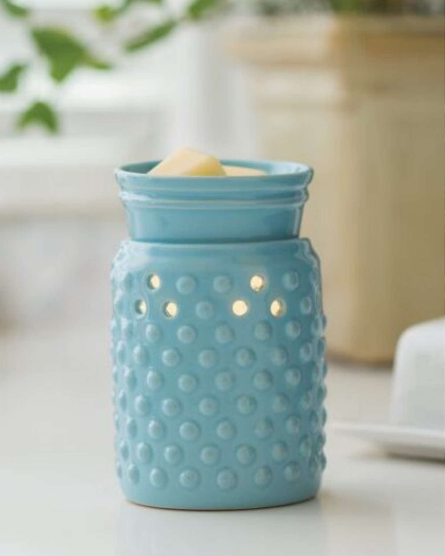 A sky blue glaze and hobnail pattern lets this versatile warmer go with either modern or traditional decor. The Midsize Illumination from Candle Warmers Etc. is a slightly smaller and more economical warmer. A perfect fit for cozier spaces in your home, this decorative fragrance warmer safely warms scented wax melts, releasing lasting fragrance throughout any room. Styled for your home, be it farmhouse or traditional or modern!