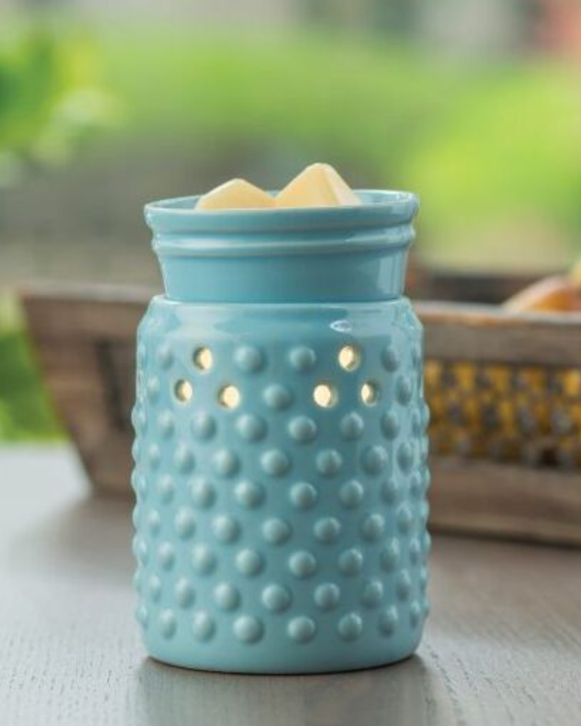 A sky blue glaze and hobnail pattern lets this versatile warmer go with either modern or traditional decor. The Midsize Illumination from Candle Warmers Etc. is a slightly smaller and more economical warmer. A perfect fit for cozier spaces in your home, this decorative fragrance warmer safely warms scented wax melts, releasing lasting fragrance throughout any room. Styled for your home, be it farmhouse or traditional or modern!